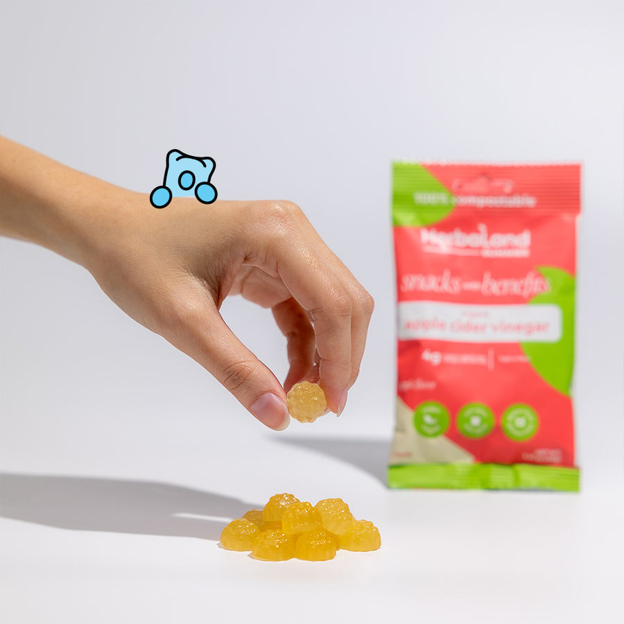 Herbaland Gummies - Person holding herbaland gummies, with the pouch of apple cider vinegar snacks with benefits in the background