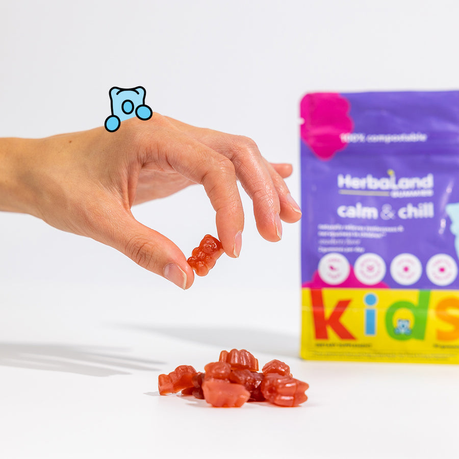 A Person holding Herbaland vitamin gummies of calm and chill for naturally relieve restlessness and nervousness in children for kids with strawberry flavor