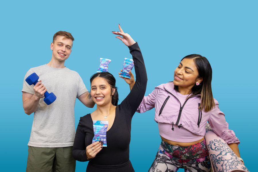 Three people in workout attire holding pre-workout gummies