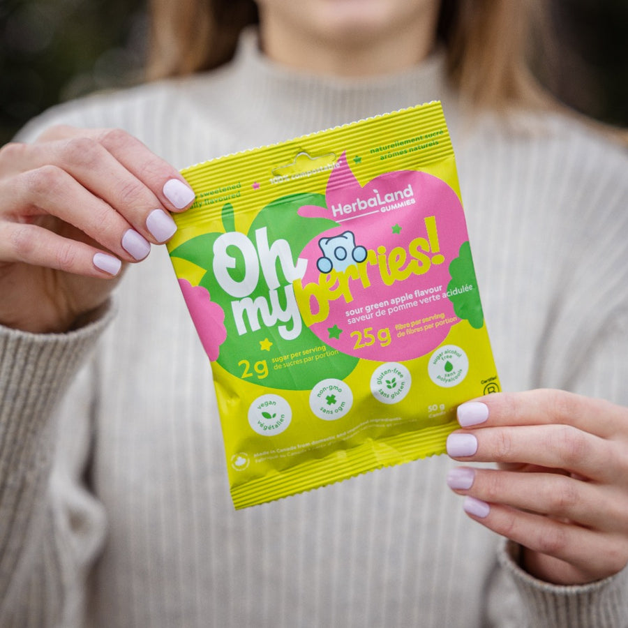 Herbaland Gummies - Lifestyle image of oh my gummies, low sugar, high fibre gummies in sour green apple flavor 