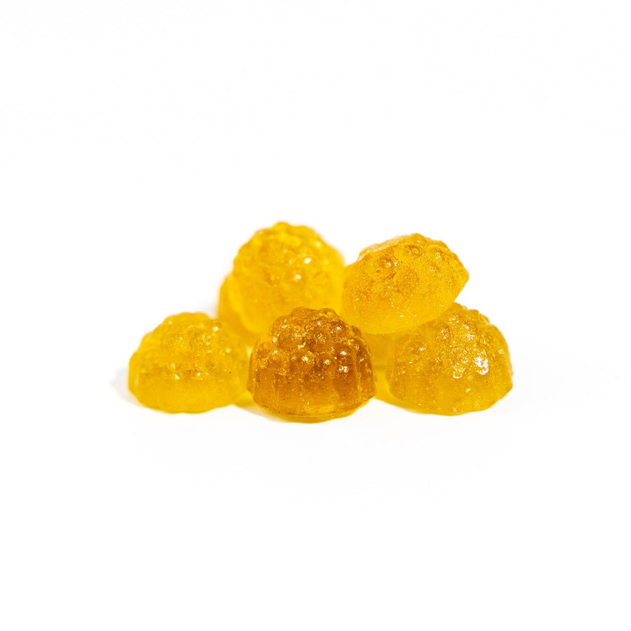 Herbaland Gummies - Close-up of low sugar, high fibre gummies in sour green apple flavor  