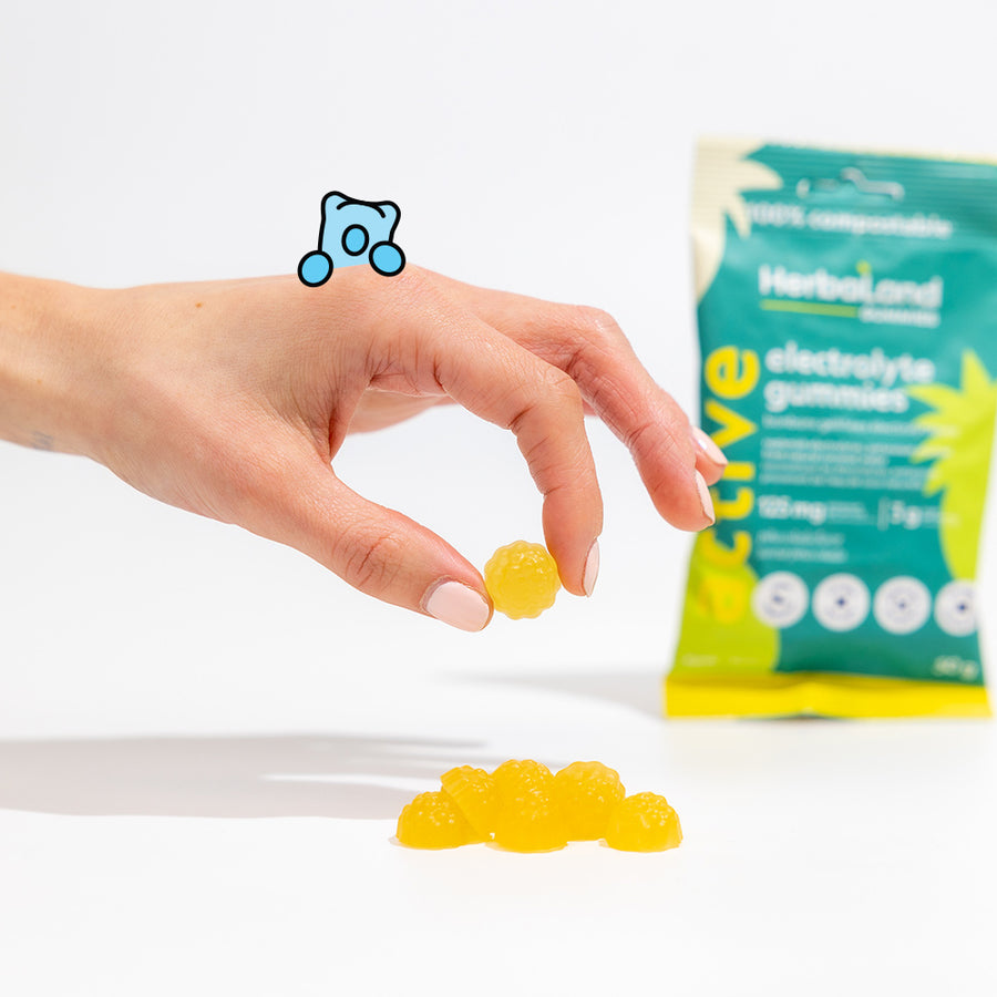 Person holding herbaland gummies, with electrolyte gummies pouch to meet your body’s needs for adults with pina colada flavor