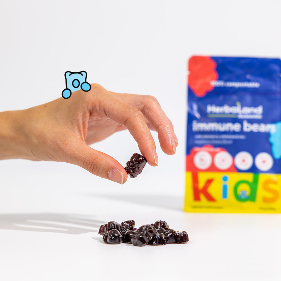 Person holding herbaland gummies, with immune bears pouch to boost immune system for kids with raspberry lemon flavor