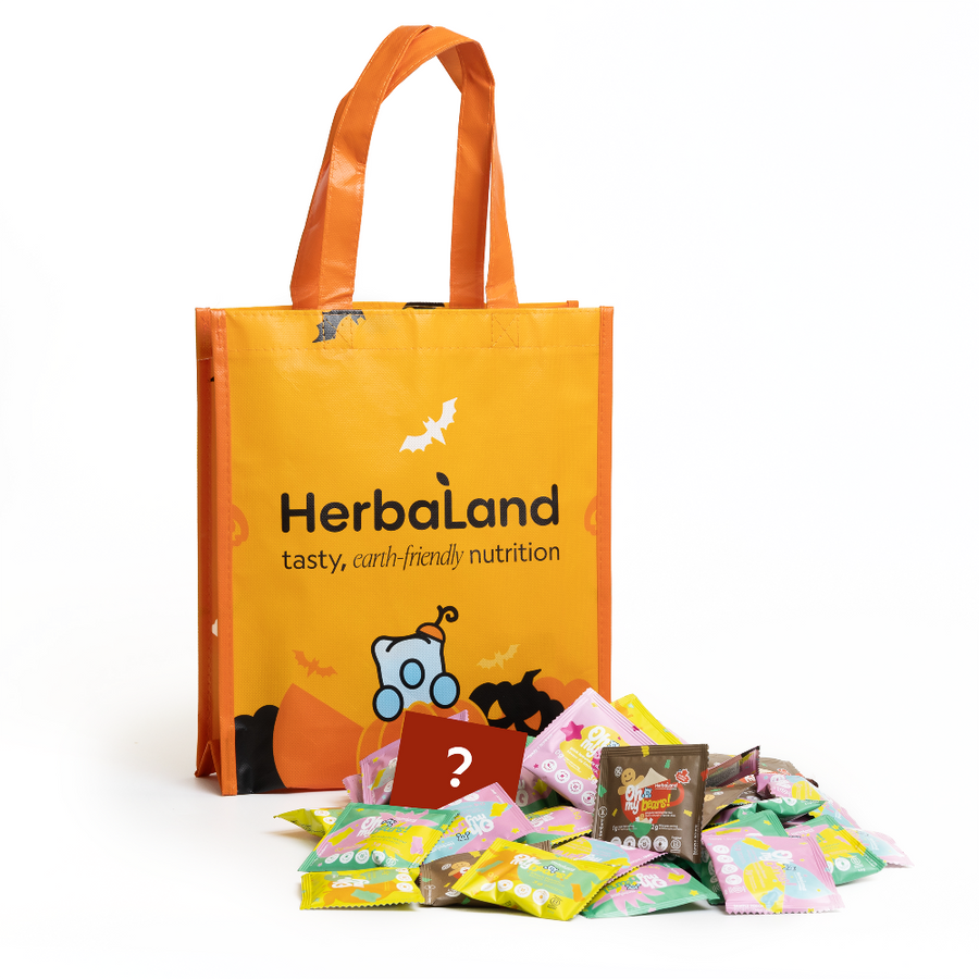 Orange tote bag with 'Herbaland' branding and scattered packets on a white background
