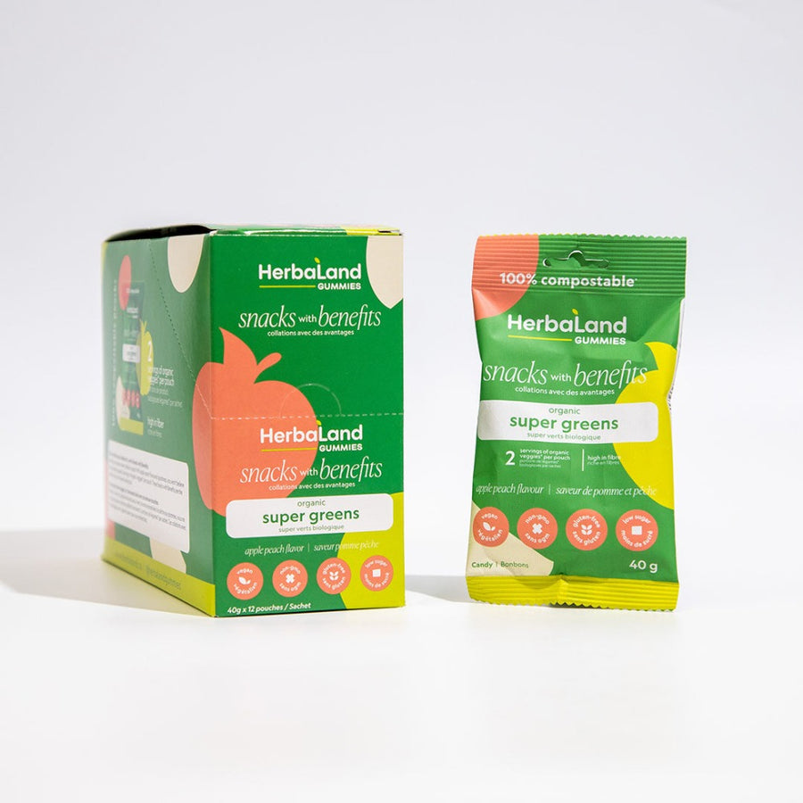 A case and a pouch of super greens herbaland snacks with benefits with apple peach flavor 
