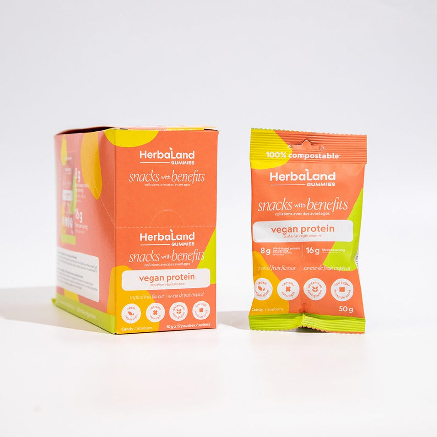 A case and a pouch of herbaland vegan protein snacks with benefits with tropical fruit flavor 